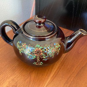 Vintage black hand painted teapot made in Japan. 4" tall 7.75" handle to Spout